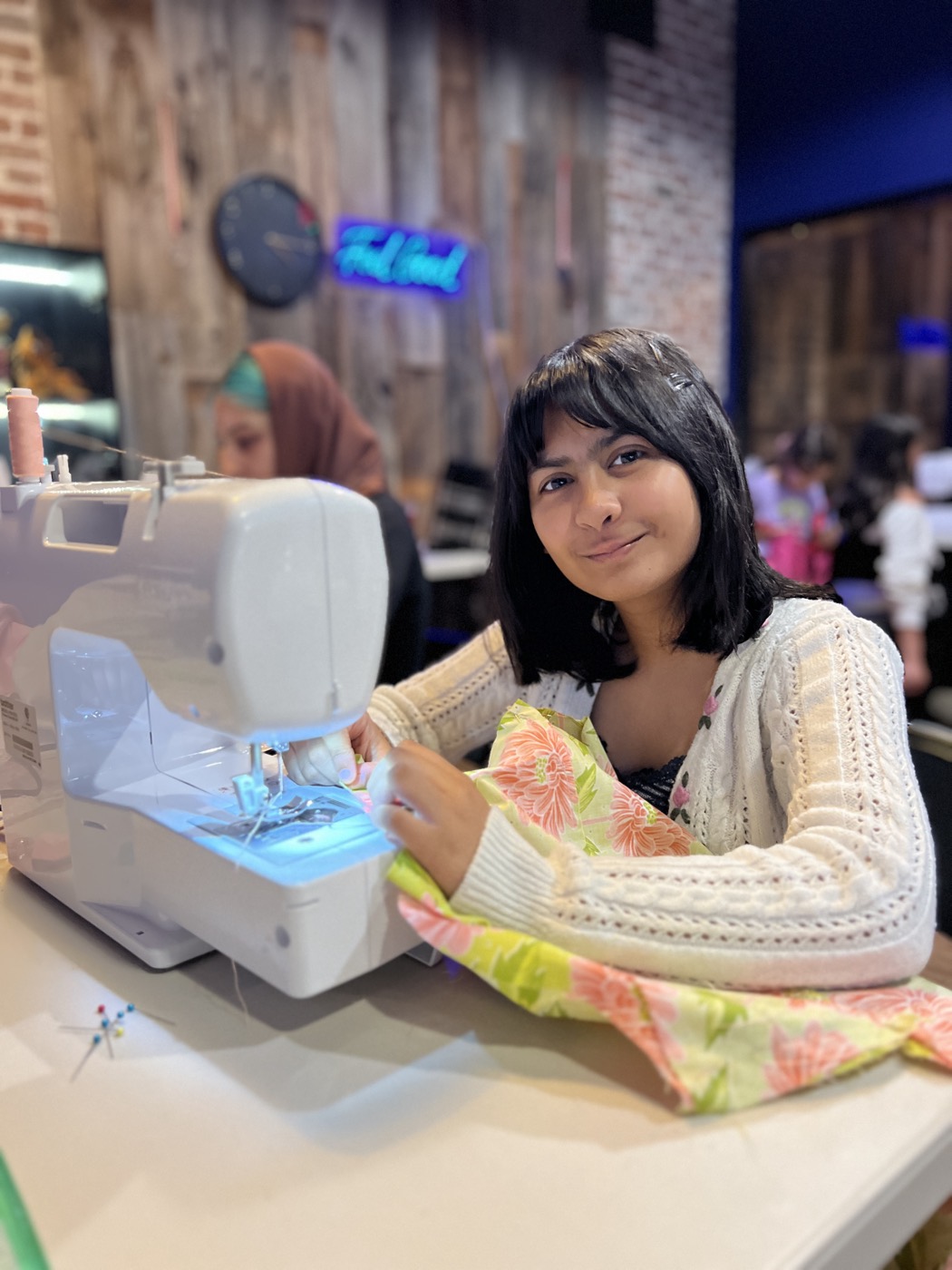 A camper sewing her garment at Long Island Fashion Camp