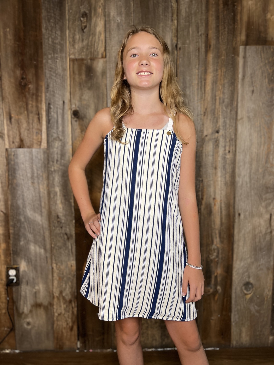 Young designer in a striped sundress she made