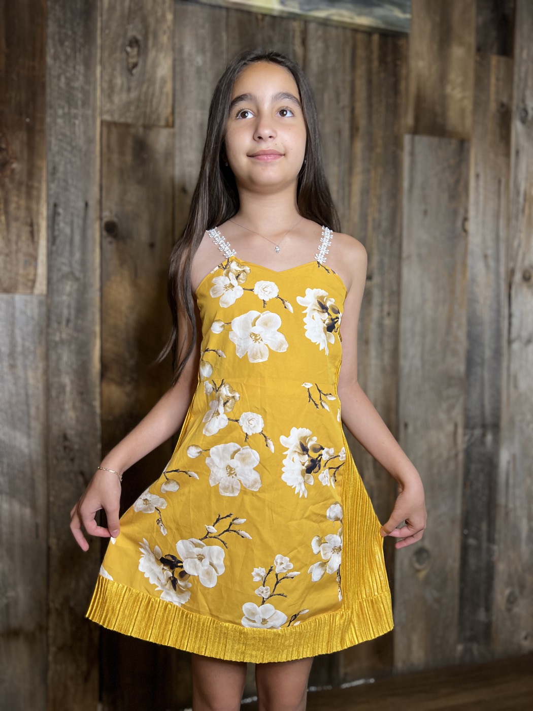 Young designer in a floral sundress she made