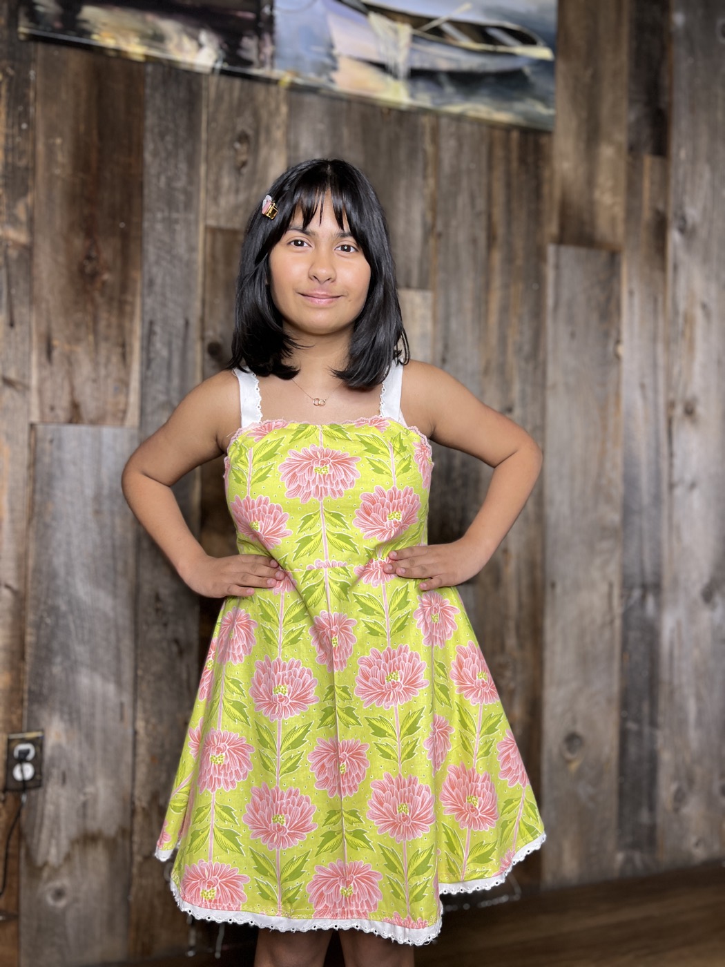 Young designer in a floral A-line dress she made