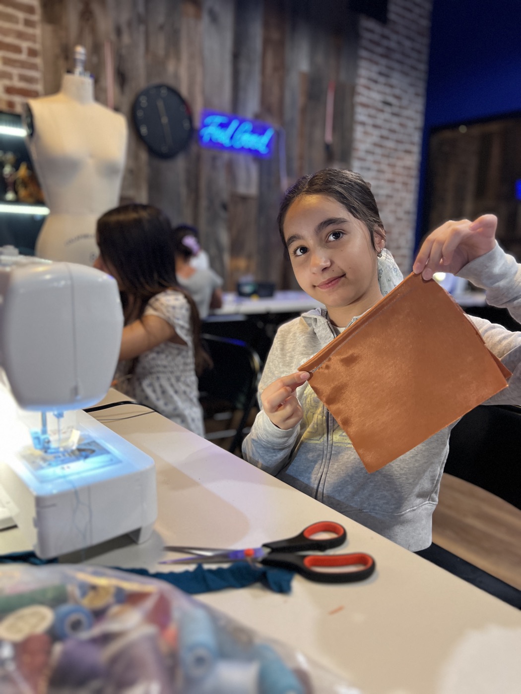 A young designer measuring and marking fabric