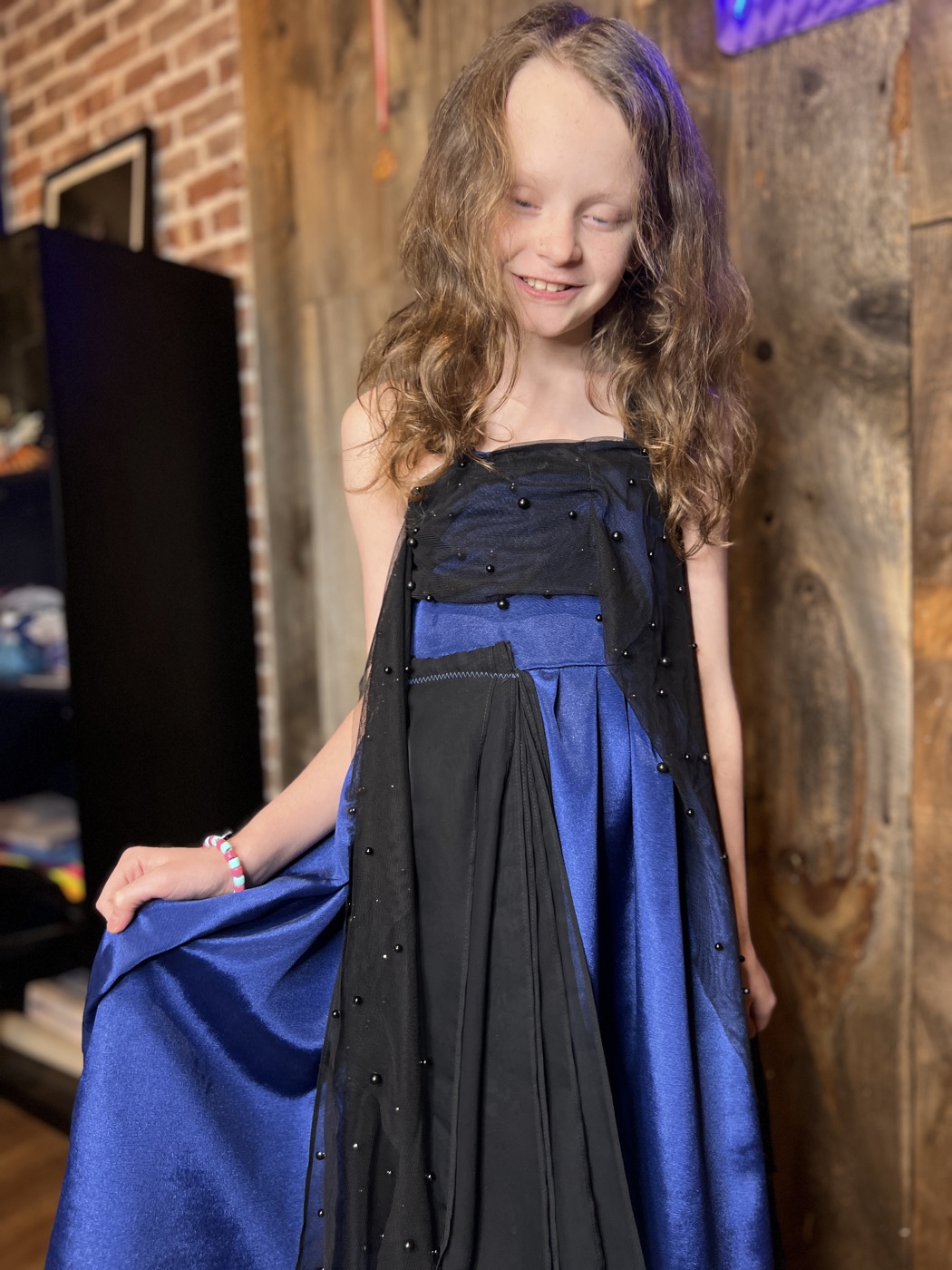 A young designer shows off her finished gown