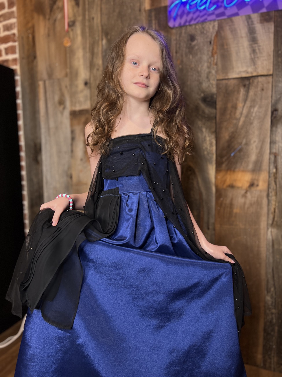 A camper models her finished gown at the finale