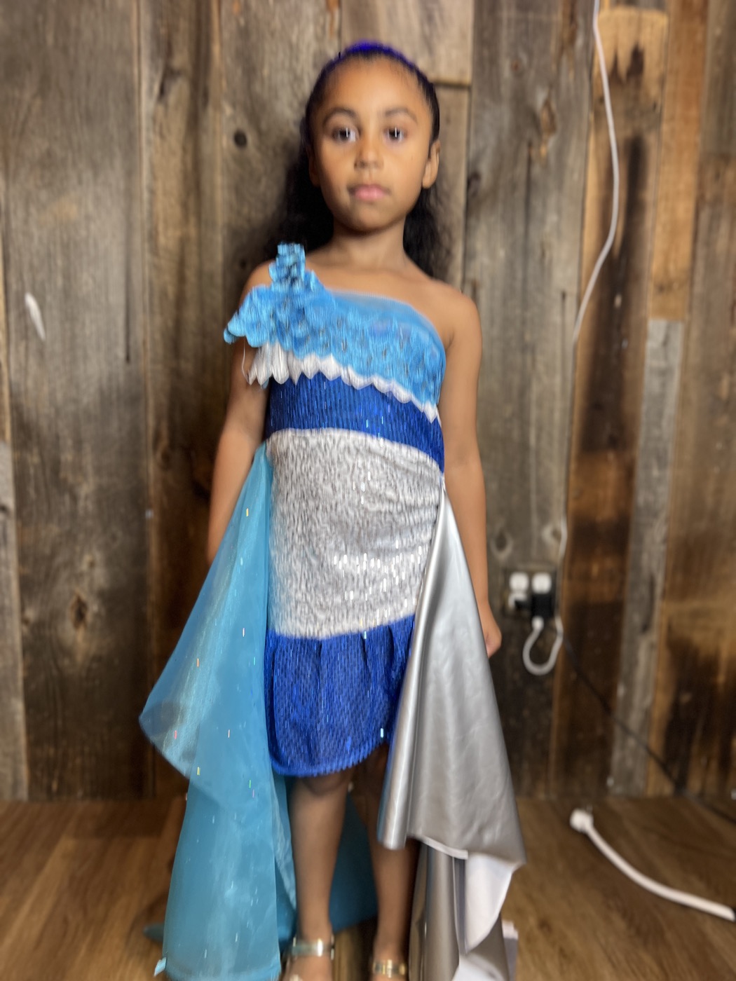 A young designer beside her design